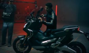 Marquez Bermain Musik Menggunakan Sepeda Motor Skuter Matik